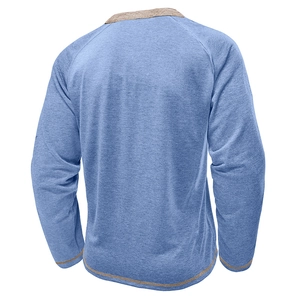 Detail of light blue raglan sleeve shirt with exposed decorative stitching and seams