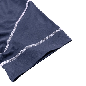 Close-up of muscle fit shirt with durable flatlock stitching and knit fabric texture