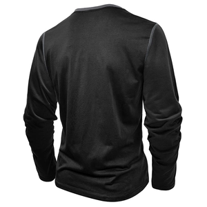 Close-up of contrast grey stitching on the back shoulder of a black men's Henley shirt
