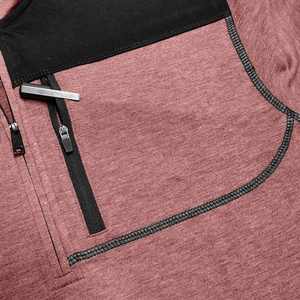 Detail of heathered red knit fabric with black chest pocket and vertical zipper closure