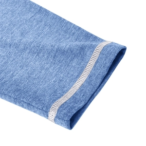 Detail of blue textured fabric with white contrast stitching on long sleeve polo shirt