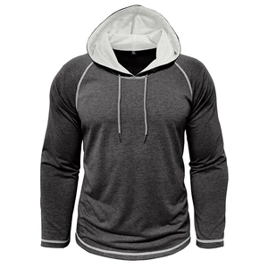 Dettaglio della maglia con cappuccio grigia con maniche raglan e cuciture bianche