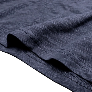 Close-up of charcoal blue slub cotton fabric with visible knit texture and double stitching