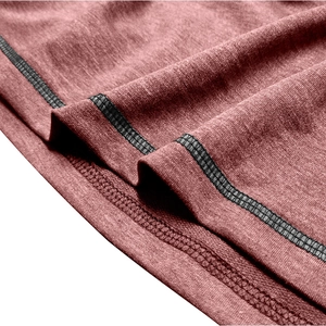 Detailed close-up showing the double-stitched hem and black trim on knit jacket fabric