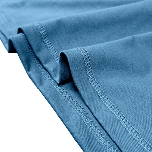 Detail of navy blue knit fabric showing double-needle stitching and fine texture of the shirt