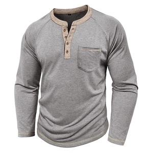 Detail of grey Henley shirt showing brown placket, wood buttons, and chest pocket
