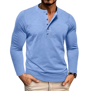 Detailed view of light blue Henley shirt with five brown buttons and slub texture fabric