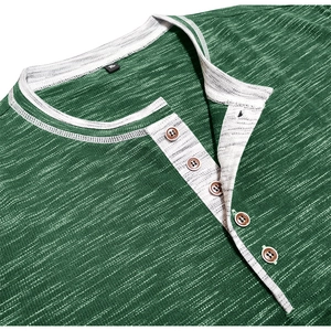 Detail view of a green textured Henley shirt with white trim and brown buttons
