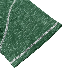 Close-up of green heather texture and white contrast stitching on the sports T-shirt sleeve