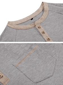 Close-up of grey Henley shirt with khaki collar detail and wooden buttons