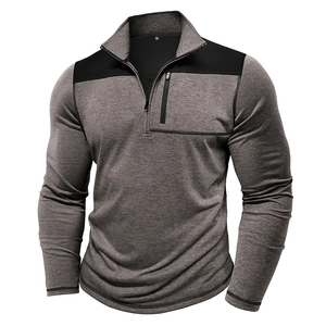 Detail of men's quarter-zip sweatshirt showing contrast shoulder panels and chest pocket