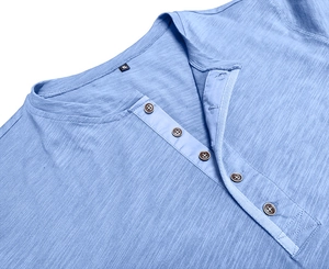 Detail of blue Henley neck shirt featuring waffle texture fabric and five brown buttons