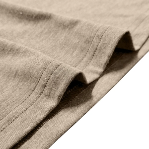 Detailed close-up of khaki knitted fabric with neat double-needle stitching on the hem