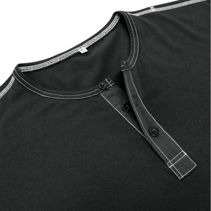 Close-up of black Henley shirt neckline with white contrast stitching and three buttons