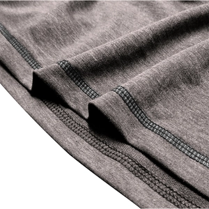 Macro shot of double-needle stitching and dark gray knit texture on tactical sweatshirt