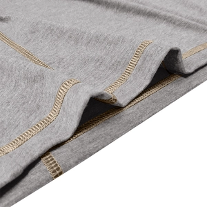 Macro detail of grey knit fabric featuring gold flatlock stitching on long sleeve polo shirt