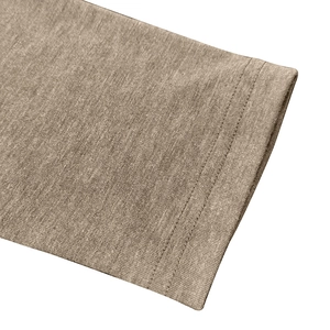 Macro shot of double-needle stitching on tan blend fabric for high-quality men's long sleeve