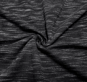 Detailed macro view of black and white melange knit fabric texture with horizontal ribbing