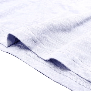 Detailed macro view of light blue slub texture knit fabric with double-needle stitching