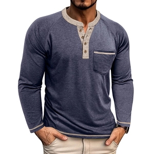 Detail of navy blue Henley shirt with four buttons, raglan sleeves and gray contrast pocket