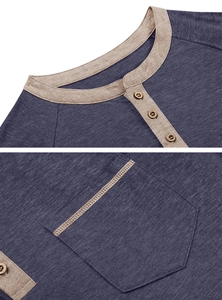 Detail of navy blue henley shirt with khaki contrast trim and wooden button closure