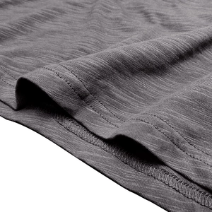 Close-up of grey slub texture knit fabric showing professional double-stitched hem finish