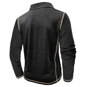 Detail of dark gray knitted long sleeve polo with khaki contrast stitching and stand collar