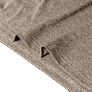 Detailed macro view of the double-needle hem and knit fabric texture on a long-sleeve polo shirt