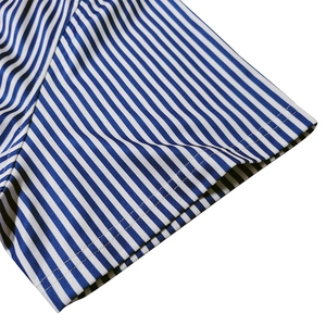 Detail of short sleeve cuff with blue and white stripes on breathable mesh fabric