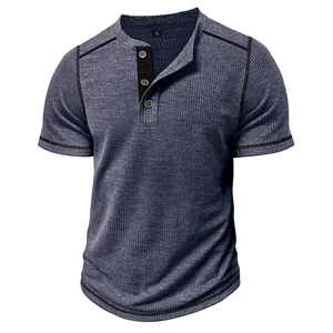 Detail of grey-blue waffle knit Henley t-shirt showing 3-button placket and black contrast trim