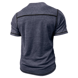 Detail view of the back of a men's waffle knit Henley shirt with blue textured fabric