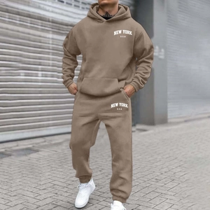 Outdoor street shot of khaki hoodie and joggers set with white NEW YORK U.S.A print