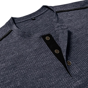 Detail of navy waffle knit shirt featuring a Henley collar with brown buttons and XL size tag