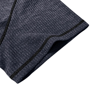 Close-up of navy waffle knit fabric with honeycomb texture and black stitching