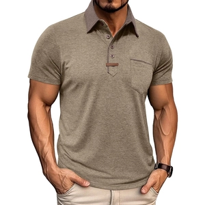 Detail of tan polo shirt featuring dark grey contrast collar and chest pocket with buttons