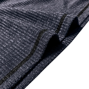 Detail of dark blue waffle knit fabric with breathable texture and durable flatlock stitching