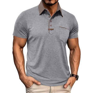 Detail of grey polo shirt featuring contrast brown collar and chest pocket with wooden buttons