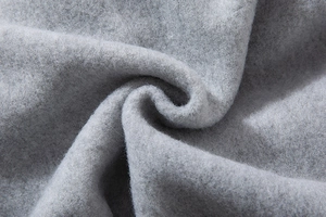 Detailed macro view of soft grey fleece fabric texture for thick oversize sweatshirt