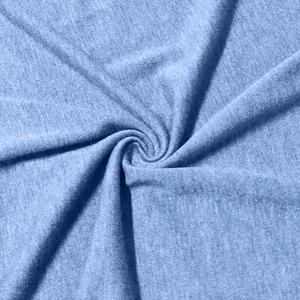 Close-up of light blue knit fabric with soft texture and spiral fold detail for polo shirt