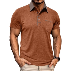 Detail of rust orange men's polo shirt featuring contrasting dark grey collar and chest pocket