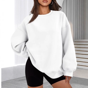 Detailed view of the oversize white crewneck sweatshirt featuring a relaxed drop shoulder fit