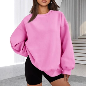 Close-up of pink oversized crewneck sweatshirt with dropped shoulders and soft texture