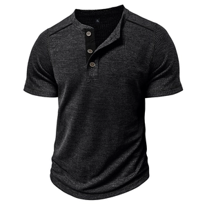 Detail view of waffle knit fabric texture and wooden buttons on men's dark grey Henley shirt