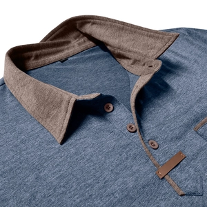 Detailed macro view of gray-blue polo shirt featuring brown contrast collar and leather trim