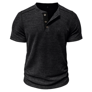 Detail of waffle knit fabric and three-button neckline on dark grey men's Henley shirt