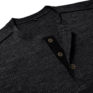 Close-up of waffle texture fabric and dark grey Henley collar with three buttons
