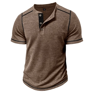 Detail of waffle knit fabric and contrast button placket on men's brown henley shirt