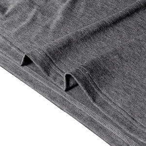 Detailed close-up of double-needle stitching on gray knitted polo shirt hemline