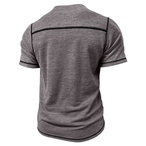 Detail view of waffle texture fabric and black contrast stitching on a men's grey t-shirt