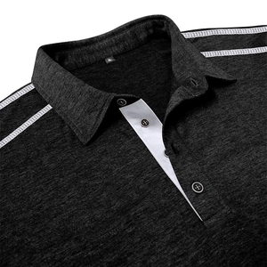 Detail of dark grey polo shirt collar with white shoulder stripes and textured fabric